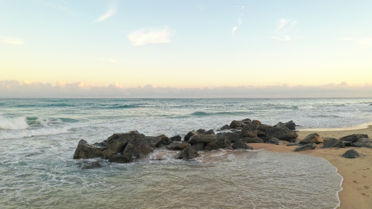 Beach waves crashing on Rocks