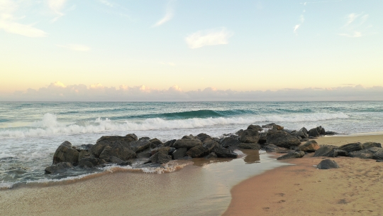 Beach waves crashing on Rocks