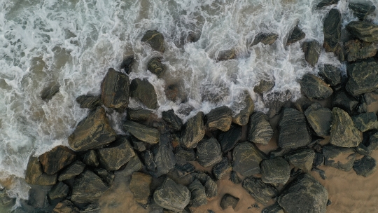 Beach waves crashing on Rocks