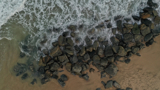 Beach waves crashing on Rocks