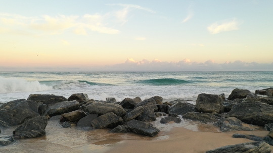 Beach waves crashing on Rocks