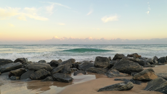 Beach waves crashing on Rocks