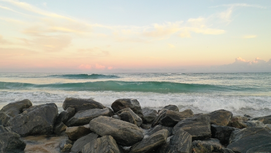 Beach waves crashing on Rocks